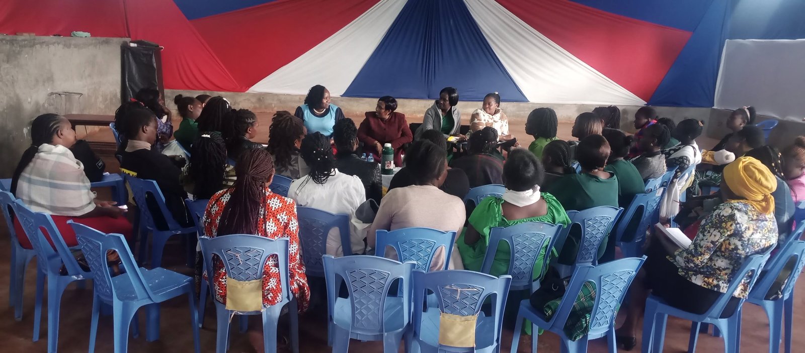 Women seated in a large circle during a Foundation women empowerment seminar.