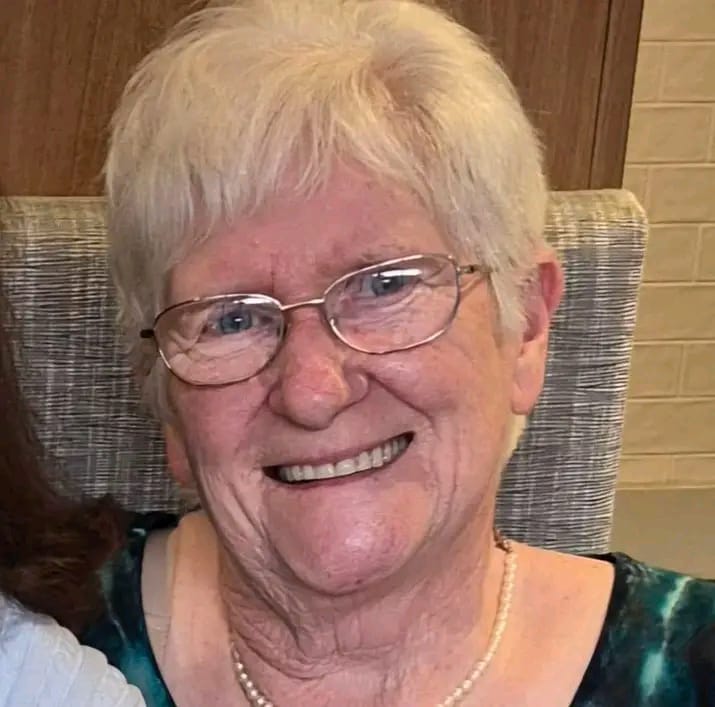 Portrait of one of the Foundation's supporters from Australia, smiling, wearing glasses and a pearl necklace.