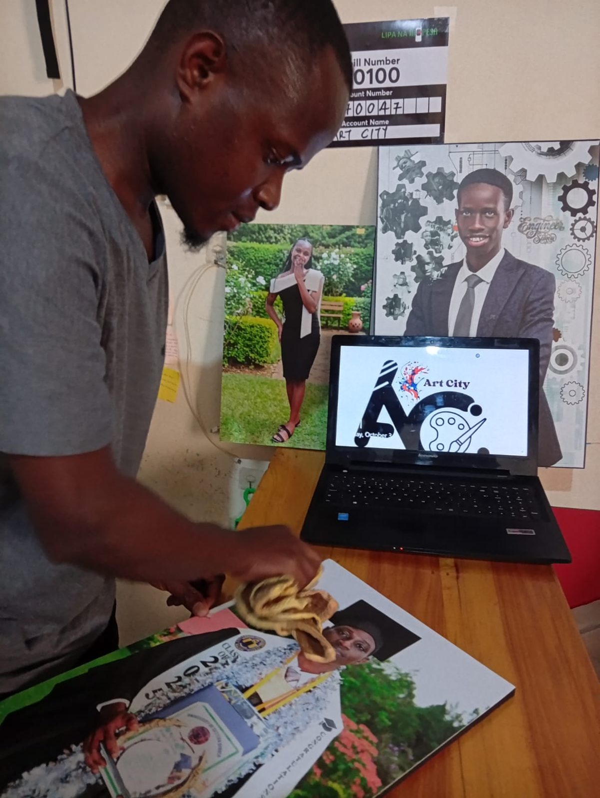 Dan finishing a mounted graduation photo in his home photography and photo-mounting business.