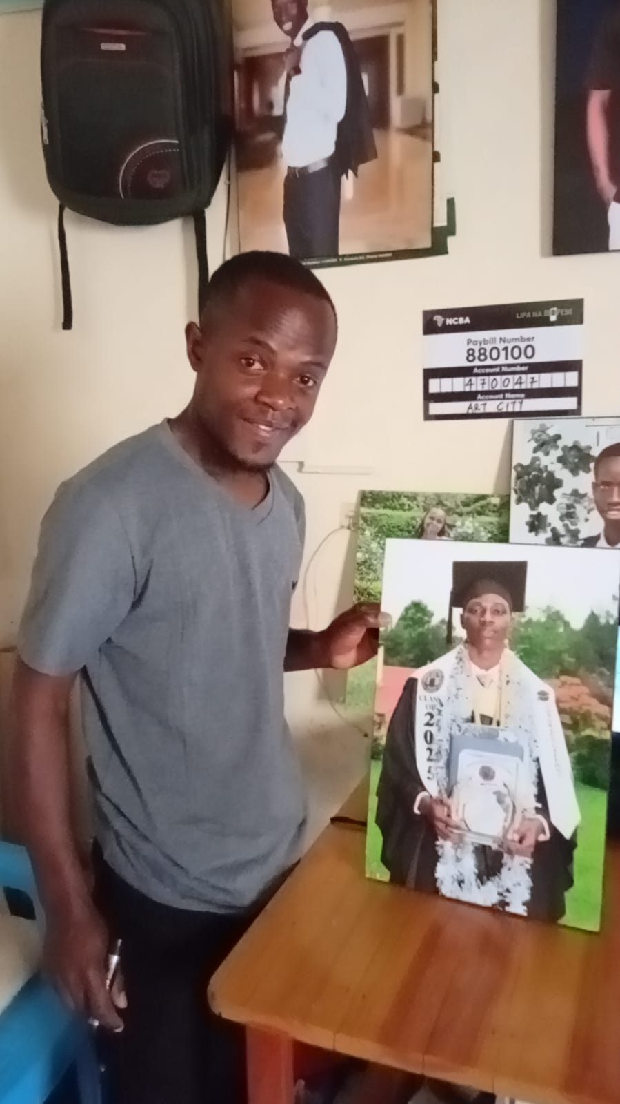 Dan holding a finished mounted graduation portrait he produced for a client.