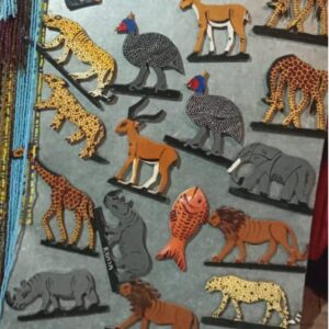 Hand-painted wooden fridge magnets shaped as African animals: giraffes, leopards, lions, elephants, rhinos, antelopes, guinea fowl and a fish.