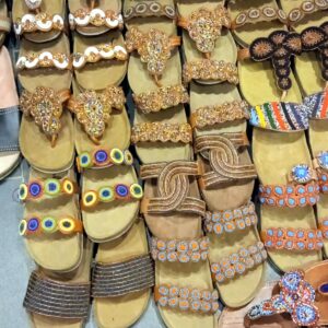 Wedge sandals with cushioned soles and beaded straps in gold, white, blue and multicolour designs.