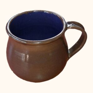 A round-bellied glazed ceramic mug, brown outside with a deep grape-blue glaze inside and a looped handle.