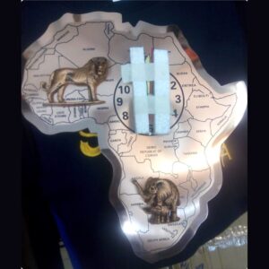 Extra-large copper wall clock cut in the shape of Africa, engraved with country borders and names, with raised lion and elephant figures.