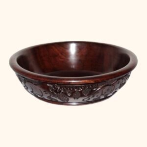 A round polished dark wood bowl with a smooth interior and a band of carved animal and plant designs around the outside.