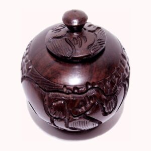 A small round dark wooden sugar pot with a knobbed lid, hand-carved with animal and leaf designs.