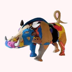 A warthog sculpture carved from multicoloured flip-flop rubber, with white tusks and a curled tail.