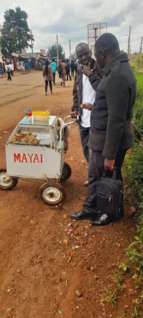 Foundation team members visiting a roadside egg vendor and his food cart.