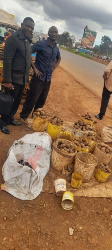 Foundation team members with a trader at his roadside potato stall.
