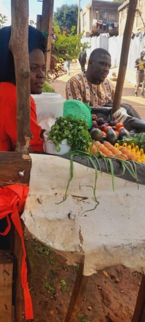 A woman at her fruit and vegetable stall during a Foundation visit.