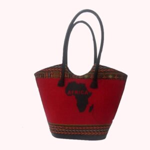 A red hand-woven tote with long black handles, a black map of Africa with the word Africa on the front, and woven Ankara-pattern bands at the top and base.