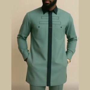 A man wearing a sage green senator suit: a long-sleeved tunic with a contrasting dark collar and front placket, two chest pockets with stitched detail, and matching trousers.