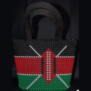 A handbag made entirely of black, red, green and white beads in the Kenyan flag design, with the Maasai shield and crossed spears in the centre and two black handles.