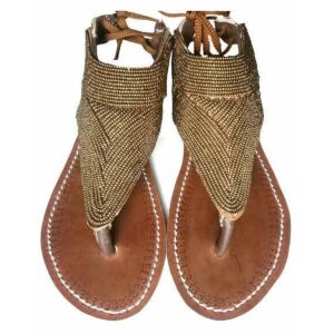 A pair of brown leather thong sandals with a high upper covered in fine bronze and gold beadwork in a chevron pattern, tied at the ankle with brown laces.