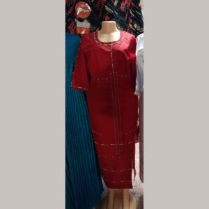A long fitted red dress on a mannequin with three-quarter sleeves and colourful Maasai beaded trim around the neckline, down the front, on the cuffs and in rows across the skirt.