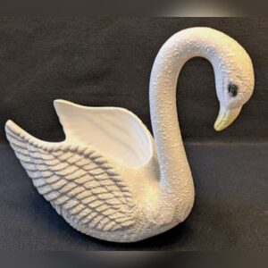 A ceramic swan planter in a textured matte white spatter glaze, with a long curved neck, sculpted feathered wings and a smooth glazed hollow for plants.
